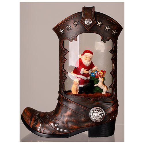 Cowboy boot with Santa Claus, snow globe with lights, music and automatic snowfall, 14x8x4 i 3