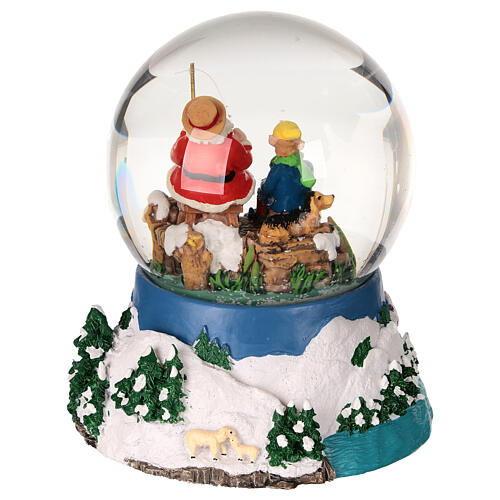 Snow globe with Santa fishing, embossed base and music box, 5x4x4 in 5