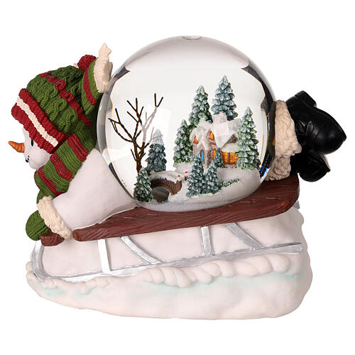 Snow globe: snowman on a sled with lights, music and automatic snowfall, 6x8x6 in 3