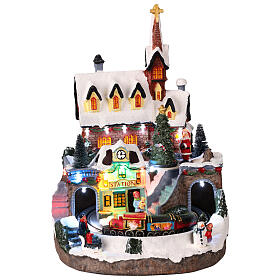 Illuminated church with animated train, 25x25x30 cm