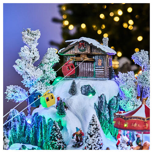 Winterszene mit LED, Seilbahn, Karussell, Schlittschuhläufern und Riesenrad – 65 × 45 × 31 cm, Strombetrieb 12