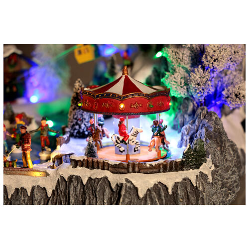 Pueblo navideño LED con teleférico, patinadores y noria 65x45x31 cm 3