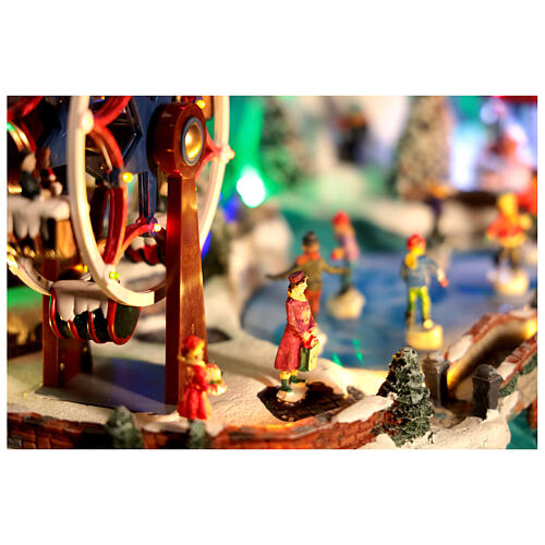 Pueblo navideño LED con teleférico, patinadores y noria 65x45x31 cm 9