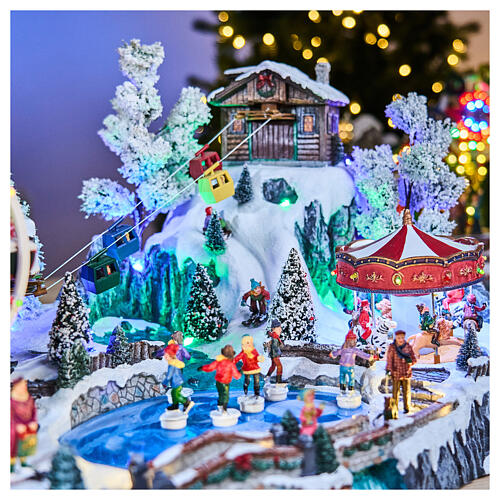 Pueblo navideño LED con teleférico, patinadores y noria 65x45x31 cm 3