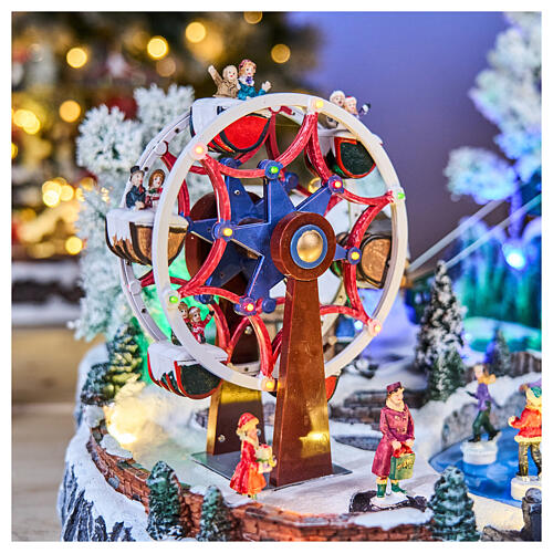 Pueblo navideño LED con teleférico, patinadores y noria 65x45x31 cm 7