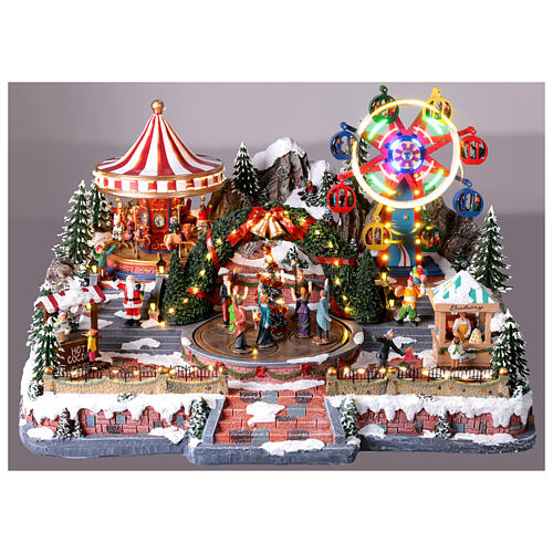 Deluxe Christmas Village: carnival in motion with colourful LED lights, 25x22x15 in, power supply 9