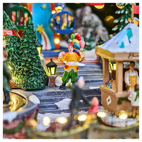 Aldea navideña Deluxe Parque de atracciones con movimiento LED coloridos 65x60x40 cm corriente 10