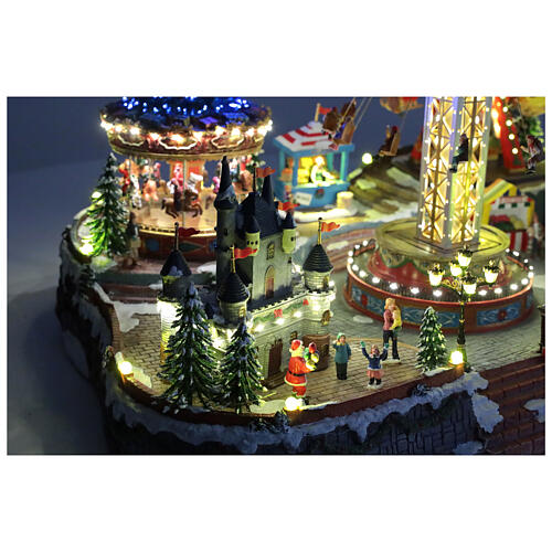 Aldea Navideña deluxe Parque de Atracciones movimiento LED coloridos 95x65x60 cm corriente 3