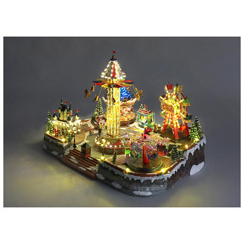 Aldea Navideña deluxe Parque de Atracciones movimiento LED coloridos 95x65x60 cm corriente 7