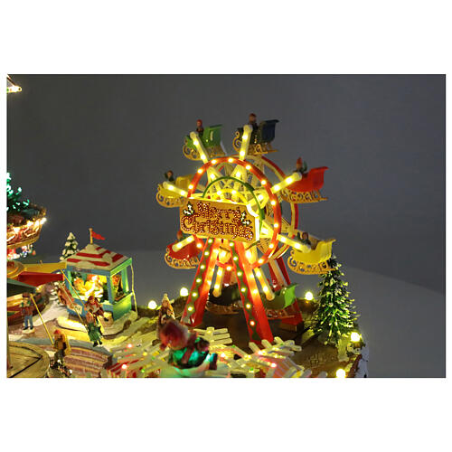 Aldea Navideña deluxe Parque de Atracciones movimiento LED coloridos 95x65x60 cm corriente 8