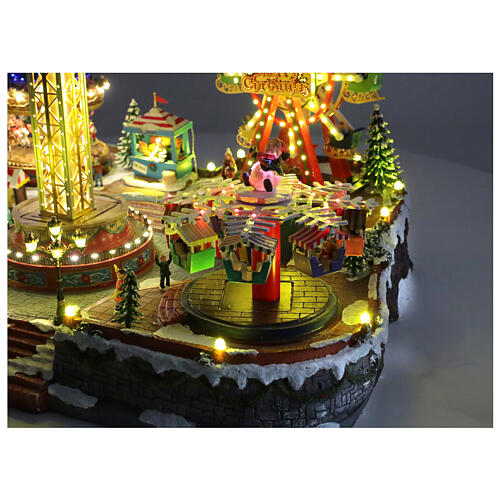 Aldea Navideña deluxe Parque de Atracciones movimiento LED coloridos 95x65x60 cm corriente 9