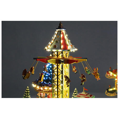 Aldea Navideña deluxe Parque de Atracciones movimiento LED coloridos 95x65x60 cm corriente 11
