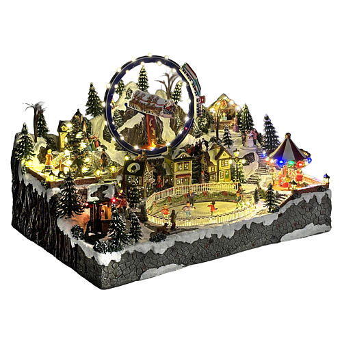 Aldea Navideña deluxe con patinadores, tren, trineo y atracciones en movimiento LED y música 65x55x45 cm con corriente 5