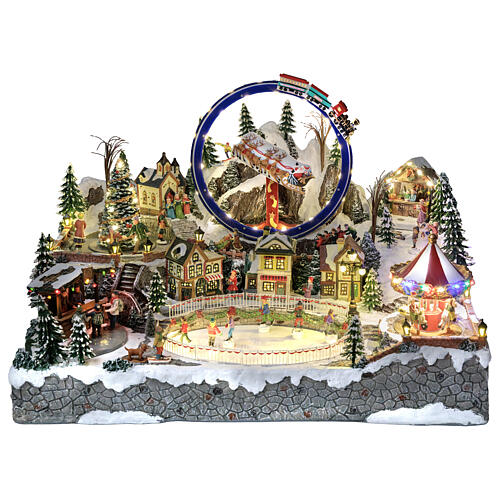 Villaggio Natalizio deluxe pattinatori giostre movimento LED musica 65x55x45 cm corrente 1