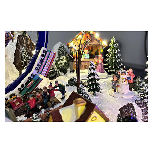 Villaggio Natalizio deluxe pattinatori giostre movimento LED musica 65x55x45 cm corrente 5