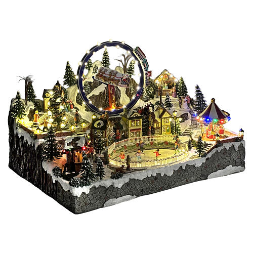 Villaggio Natalizio deluxe pattinatori giostre movimento LED musica 65x55x45 cm corrente 6