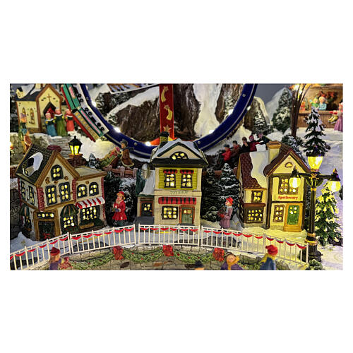 Villaggio Natalizio deluxe pattinatori giostre movimento LED musica 65x55x45 cm corrente 9