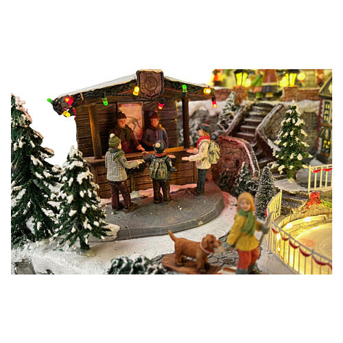 Villaggio Natalizio deluxe pattinatori giostre movimento LED musica 65x55x45 cm corrente 11