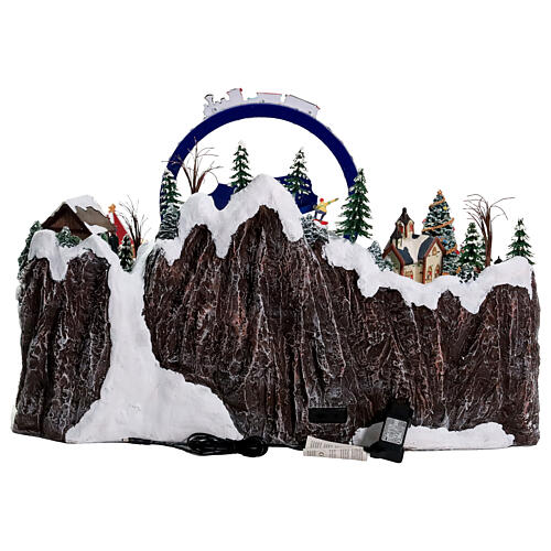 Villaggio Natalizio deluxe pattinatori giostre movimento LED musica 65x55x45 cm corrente 13