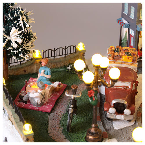 Pueblo navideño ciudad patinadores carrusel movimiento LED coloridos 60x50x25 cm eléctrico 8