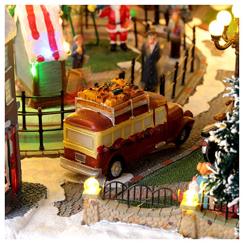 Pueblo navideño ciudad patinadores carrusel movimiento LED coloridos 60x50x25 cm eléctrico 11