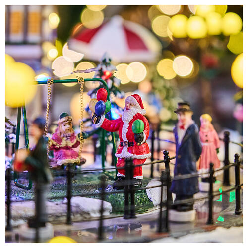 Pueblo navideño ciudad patinadores carrusel movimiento LED coloridos 60x50x25 cm eléctrico 10