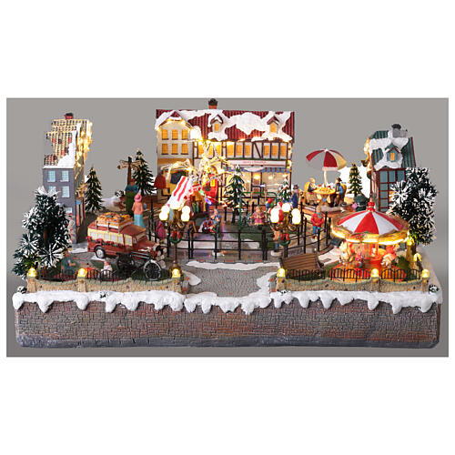 Pueblo navideño ciudad patinadores carrusel movimiento LED coloridos 60x50x25 cm eléctrico 10