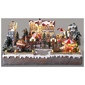 Villaggio Natalizio città pattinatori giostra movimento LED colorati 60x50x25 cm corrente