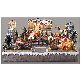 Villaggio Natalizio città pattinatori giostra movimento LED colorati 60x50x25 cm corrente