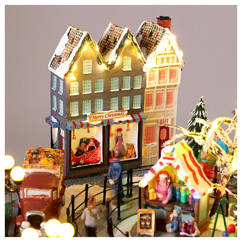 Villaggio Natalizio città pattinatori giostra movimento LED colorati 60x50x25 cm corrente 7