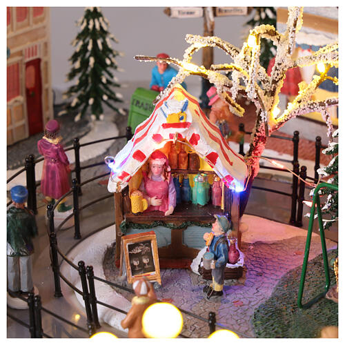 Villaggio Natalizio città pattinatori giostra movimento LED colorati 60x50x25 cm corrente 13