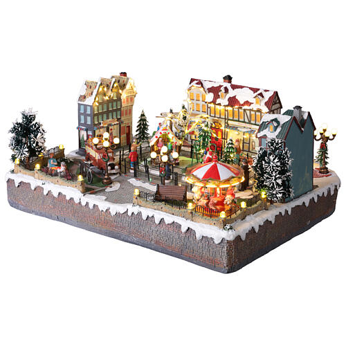 Villaggio Natalizio città pattinatori giostra movimento LED colorati 60x50x25 cm corrente 6