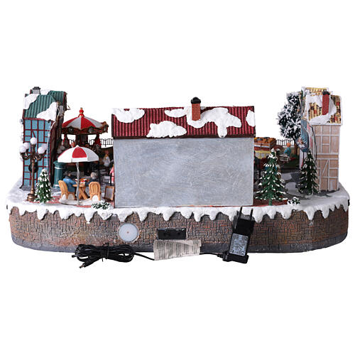 Villaggio Natalizio città pattinatori giostra movimento LED colorati 60x50x25 cm corrente 13