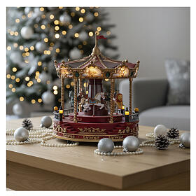 Red Christmas carousel with music, lights, and movement 23x25 cm
