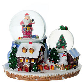 Boule à neige cadeaux Père Noël et village 15x10x12 cm