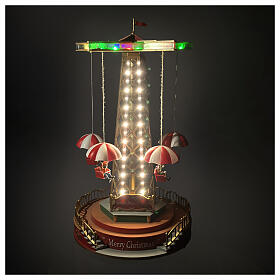 Christmas carousel with animated parachutes, lights, and music, 10x10x18 in