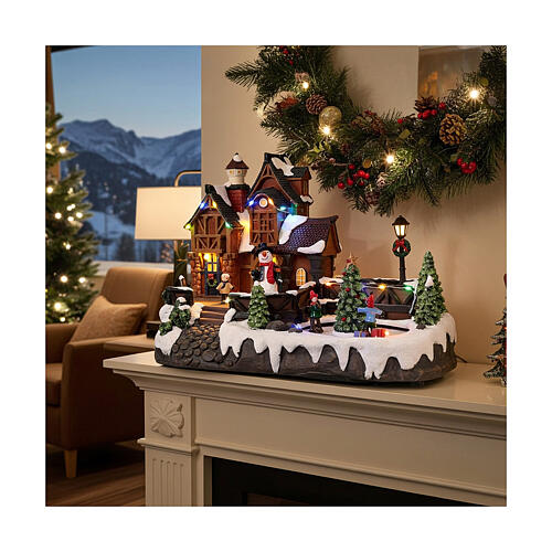 Casa de Navidad con patinadores sobre hielo animados 35x20x25 cm 2