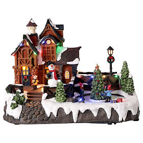 Casa di Natale con pattinatori sul ghiaccio animati 35x20x25 cm