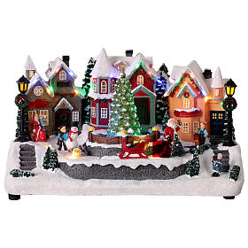 Village de Noël avec Père Noël animé LEDs et musique 30x20x20 cm