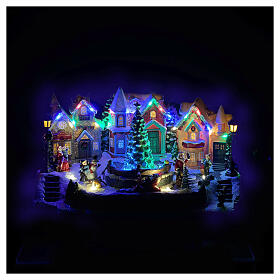 Village de Noël avec Père Noël animé LEDs et musique 30x20x20 cm