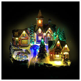 Christmas village scene with animated skaters and lights, 14x8x12 in