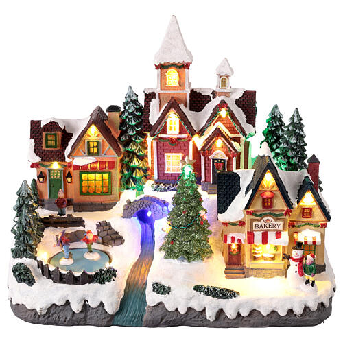 Scena del villaggio natalizio con pattinatori animati luci e misura 35x20x30 cm 1