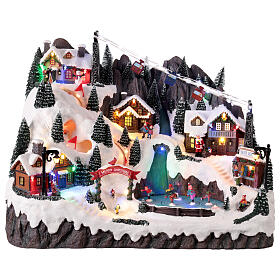 Scène de montagne avec enfants patinant, lumières et musique animées 55x35x40 cm