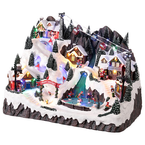 Scena di montagna con bambini che pattinano animati luci e musica 55x35x40 cm 3