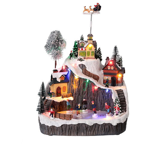 Montagna con pista di pattinaggio e slitta animata luci e musica 30x20x30 cm 1