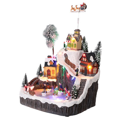Montagna con pista di pattinaggio e slitta animata luci e musica 30x20x30 cm 3