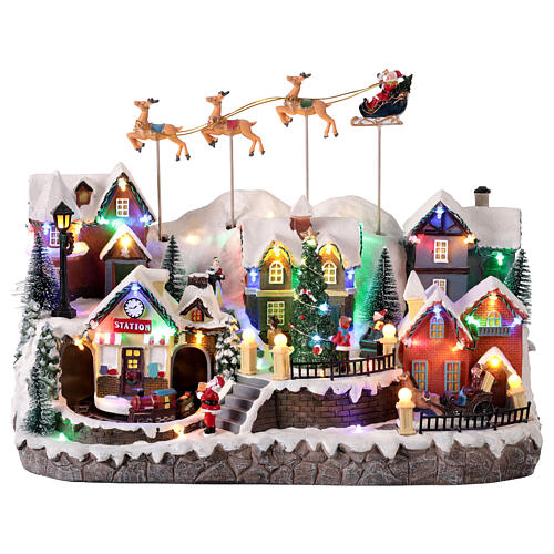 Villaggio di Natale con renne e Babbo Natale volanti animati luci e musica 40x25x30 cm 1
