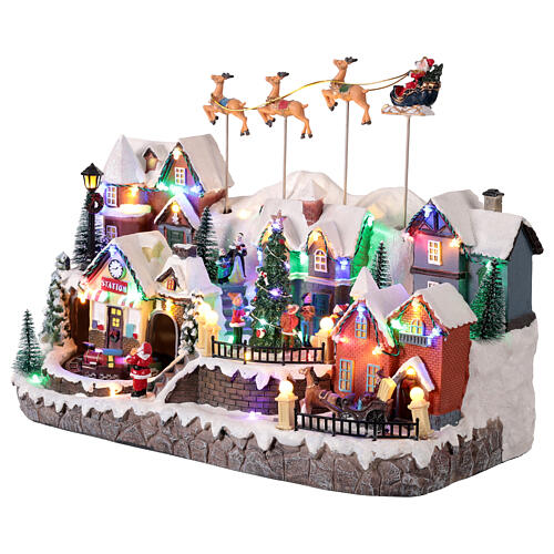 Aldeia de Natal com renas e Pai Natal voando animados, luzes e música, 40x25x30 cm 3