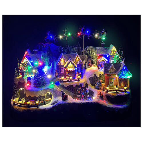 Pueblo montañoso con arroyo y patinadores animados luces y música 60x35x40 cm 2