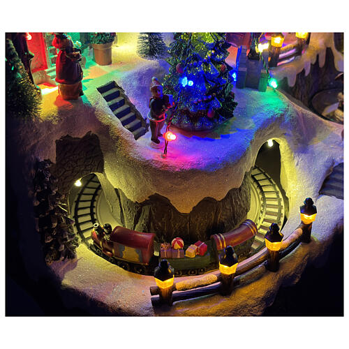 Pueblo montañoso con arroyo y patinadores animados luces y música 60x35x40 cm 4